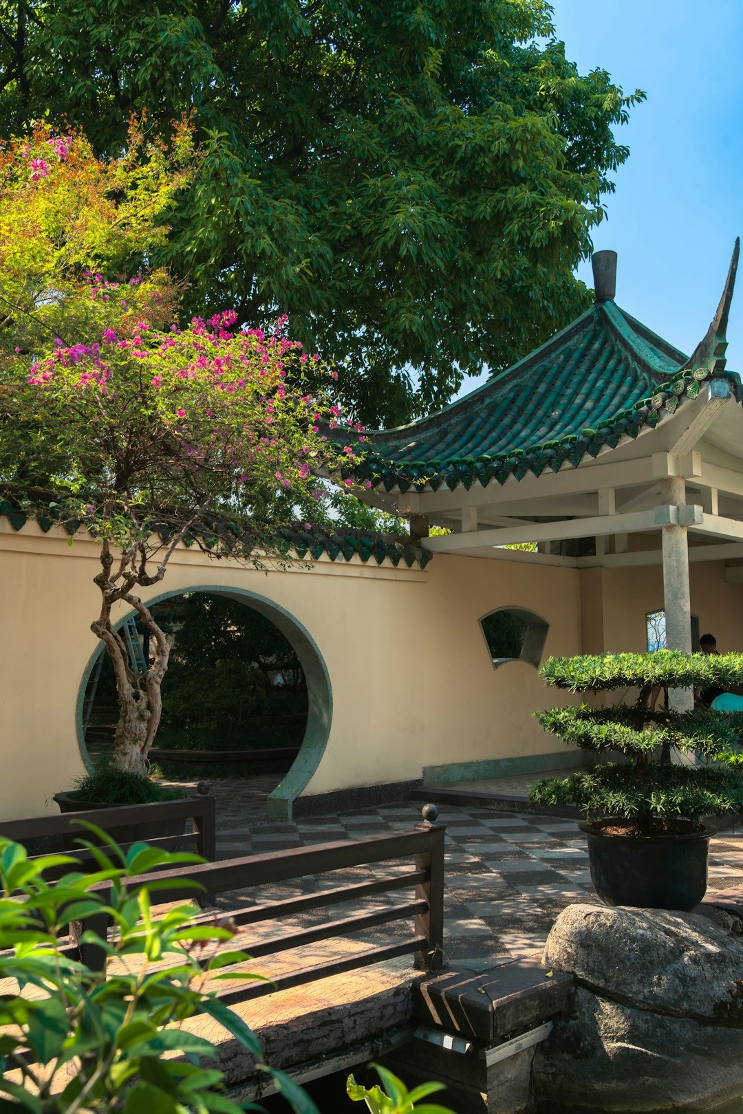 Traditional garden featuring a moon gate and pavilion.